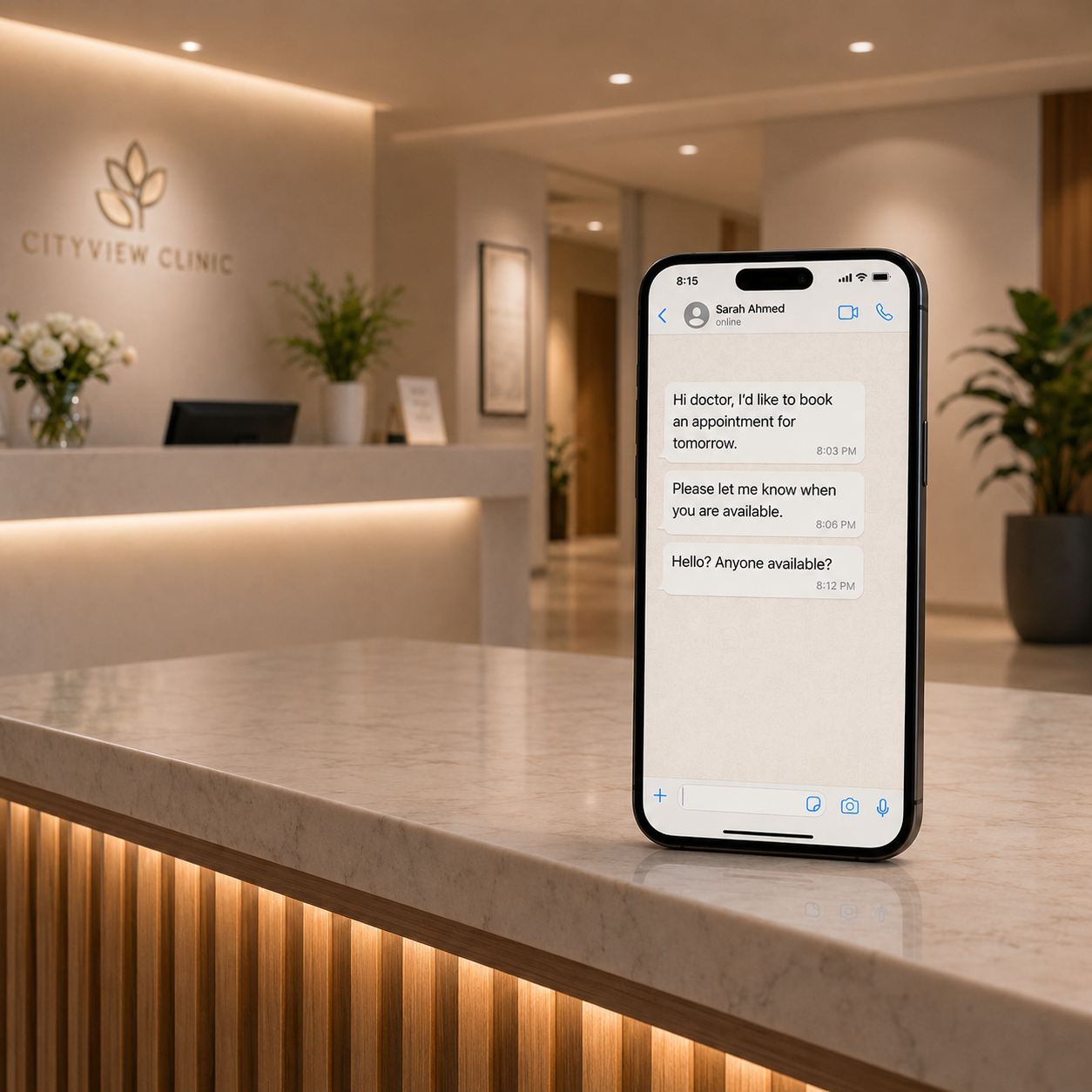 Smartphone glowing with a WhatsApp notification on an empty clinic reception desk at night